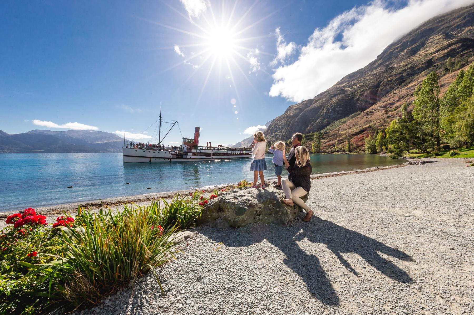 Family at Walter Peak watching the TSS Earnslaw steamship