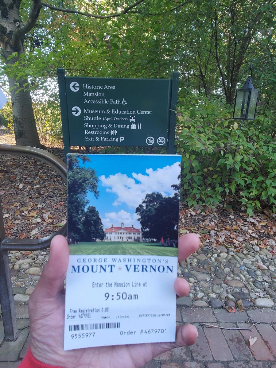 Picture of someone holding an admission ticket to Mount Vernon in front of camera
