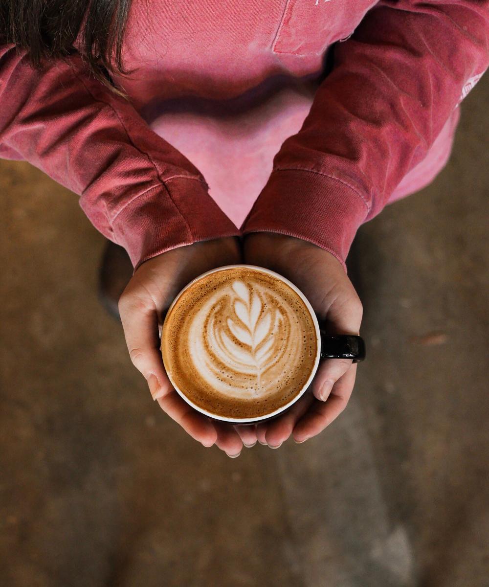 Person Holding Flat White Coffee