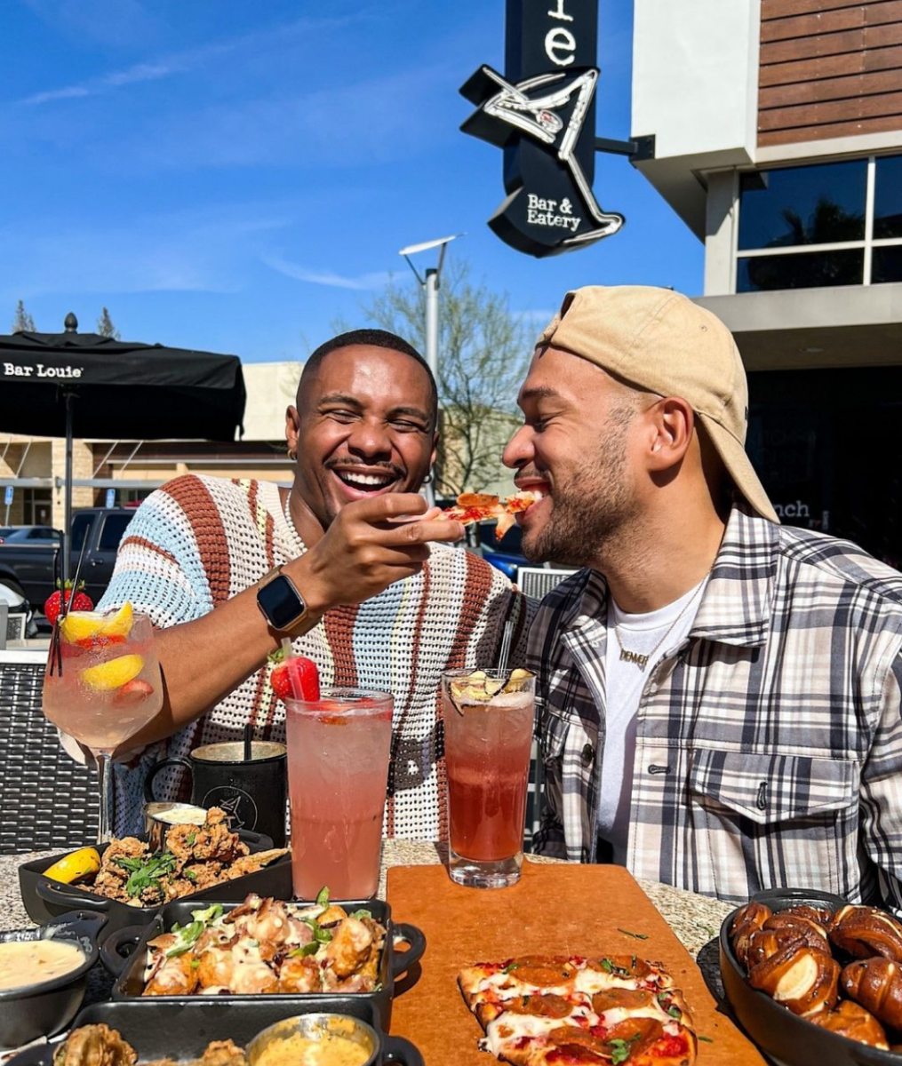 Men Sharing A Pizza At Bar Louie In Irving, TX