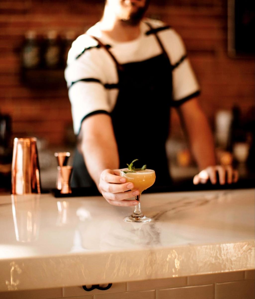 Bartender at Paramount Ballroom in Cheyenne serving a refreshing summer cocktail.