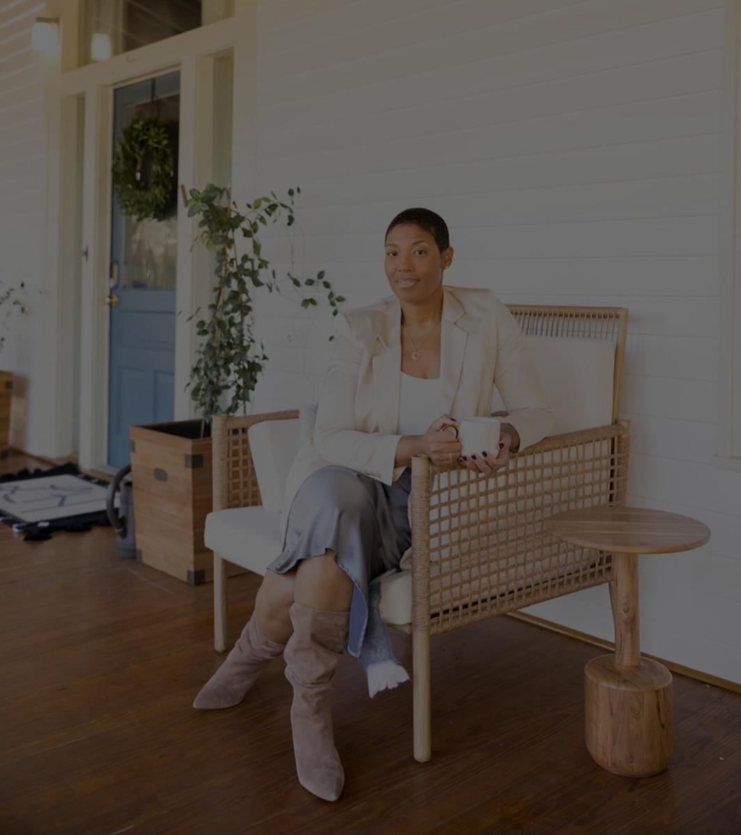 Jihan Bradford, owner of Lavender Hill Bed & Breakfast, sits on the porch of her B&B.