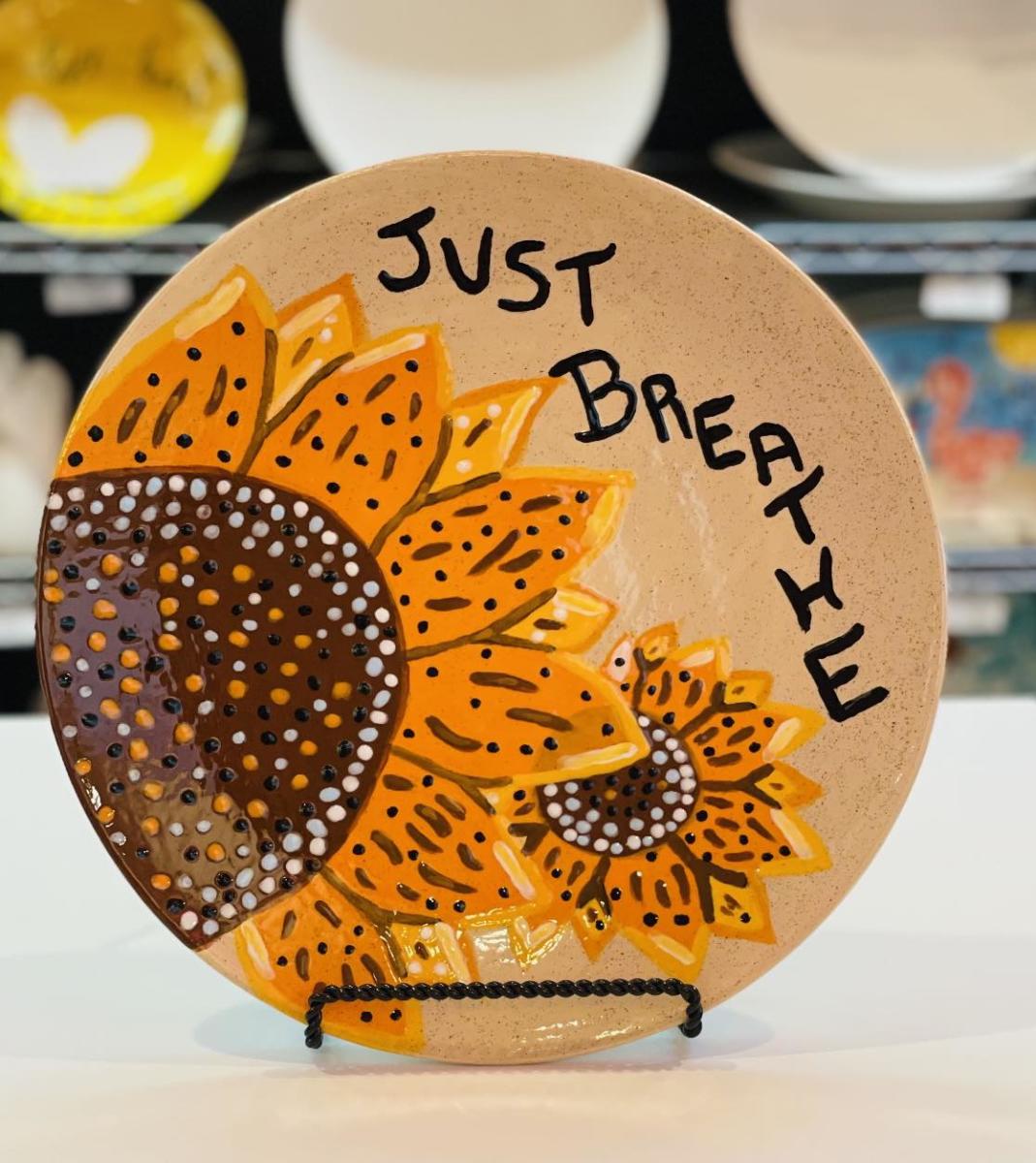 painted plate with sunflowers and the words "just breathe"