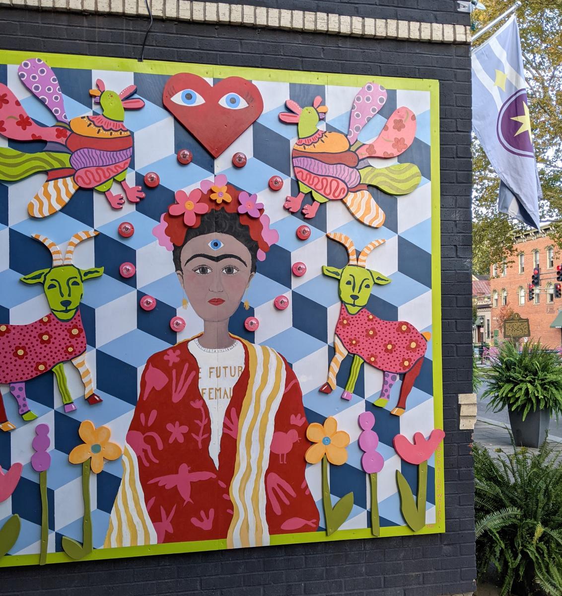 Mural designed like a multi-colored quilt with a portrait of Frida Kahlo in the center
