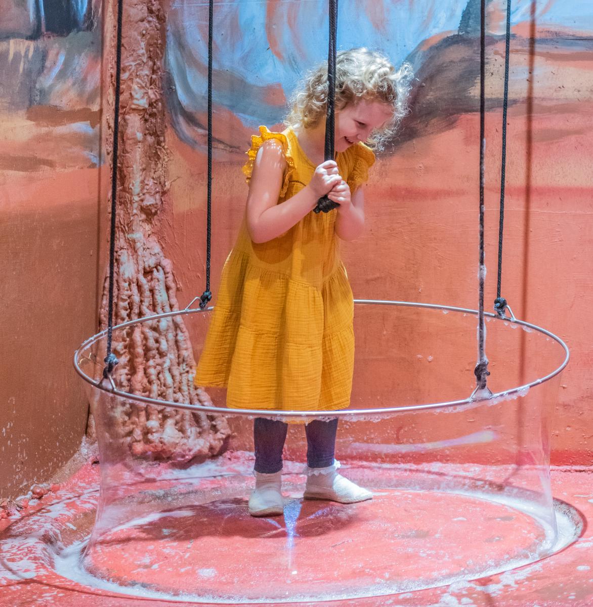 girl inside a giant bubble ring