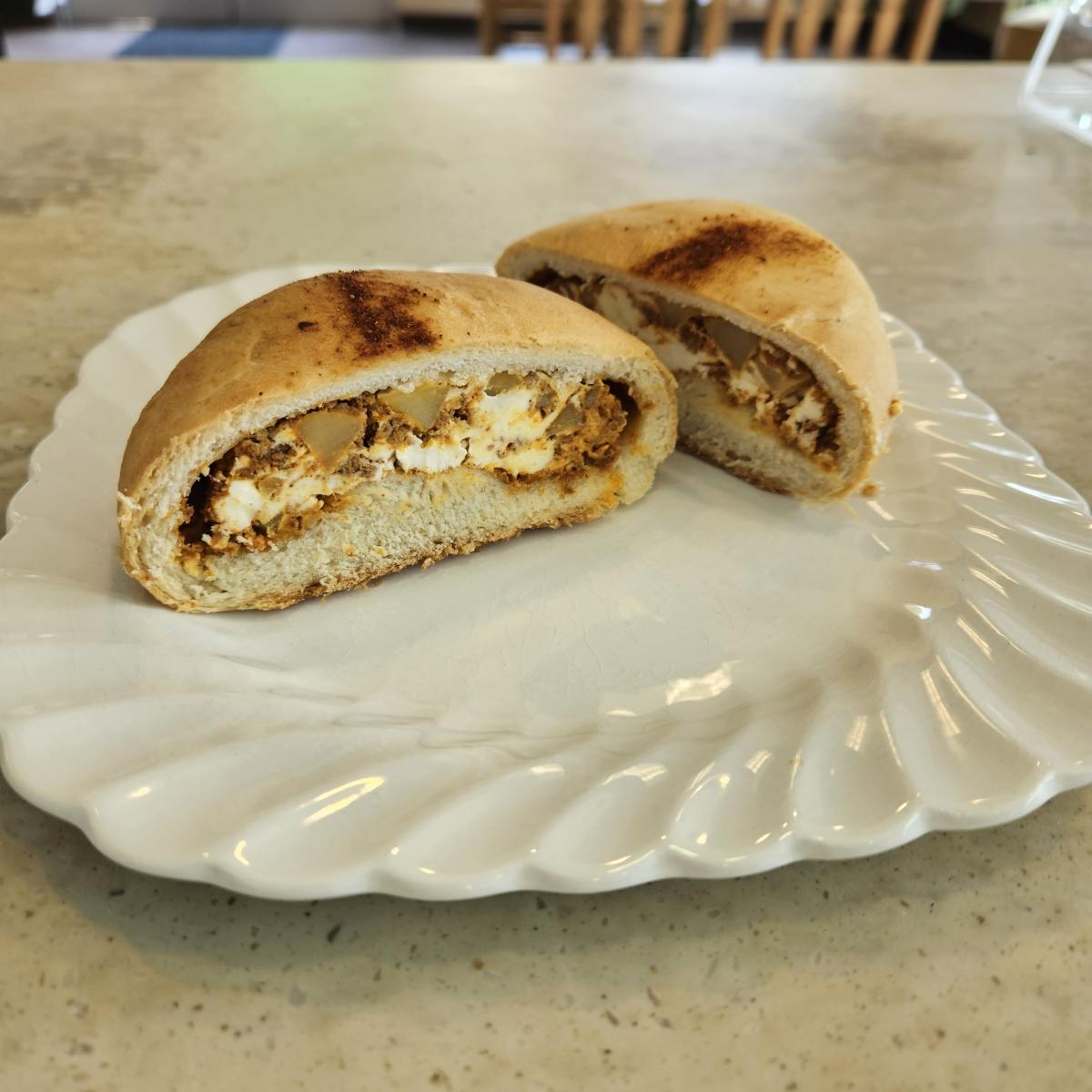 A photo of a kolache from Snapdragon Tea cut in half.