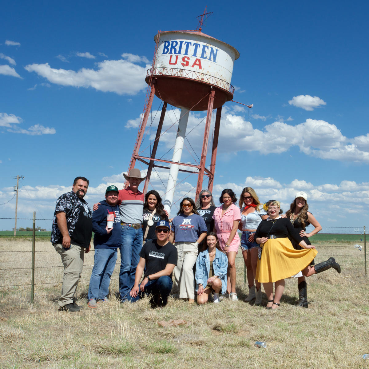 A group of tourists posed in front of the Leaning Tower of Texas Road Side Attraction in Texas