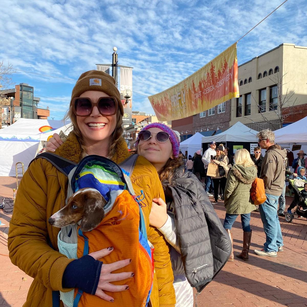 A family and their dog enjoying the Firefly Holiday Market.