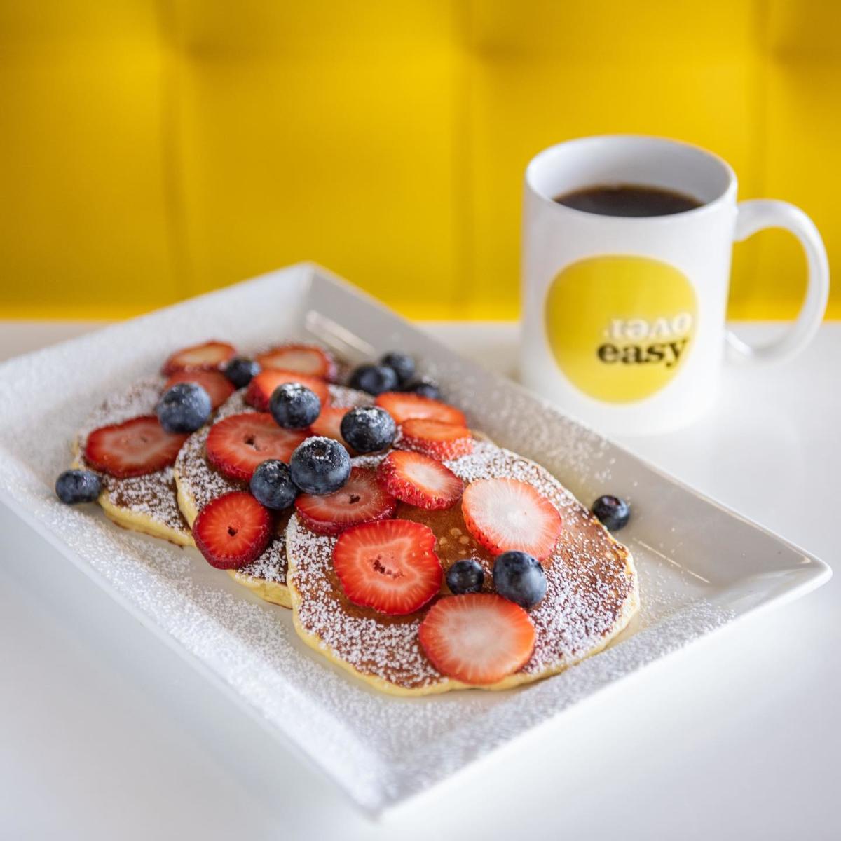 Over Easy in Chandler, AZ - Pancakes topped with fruit and powdered sugar