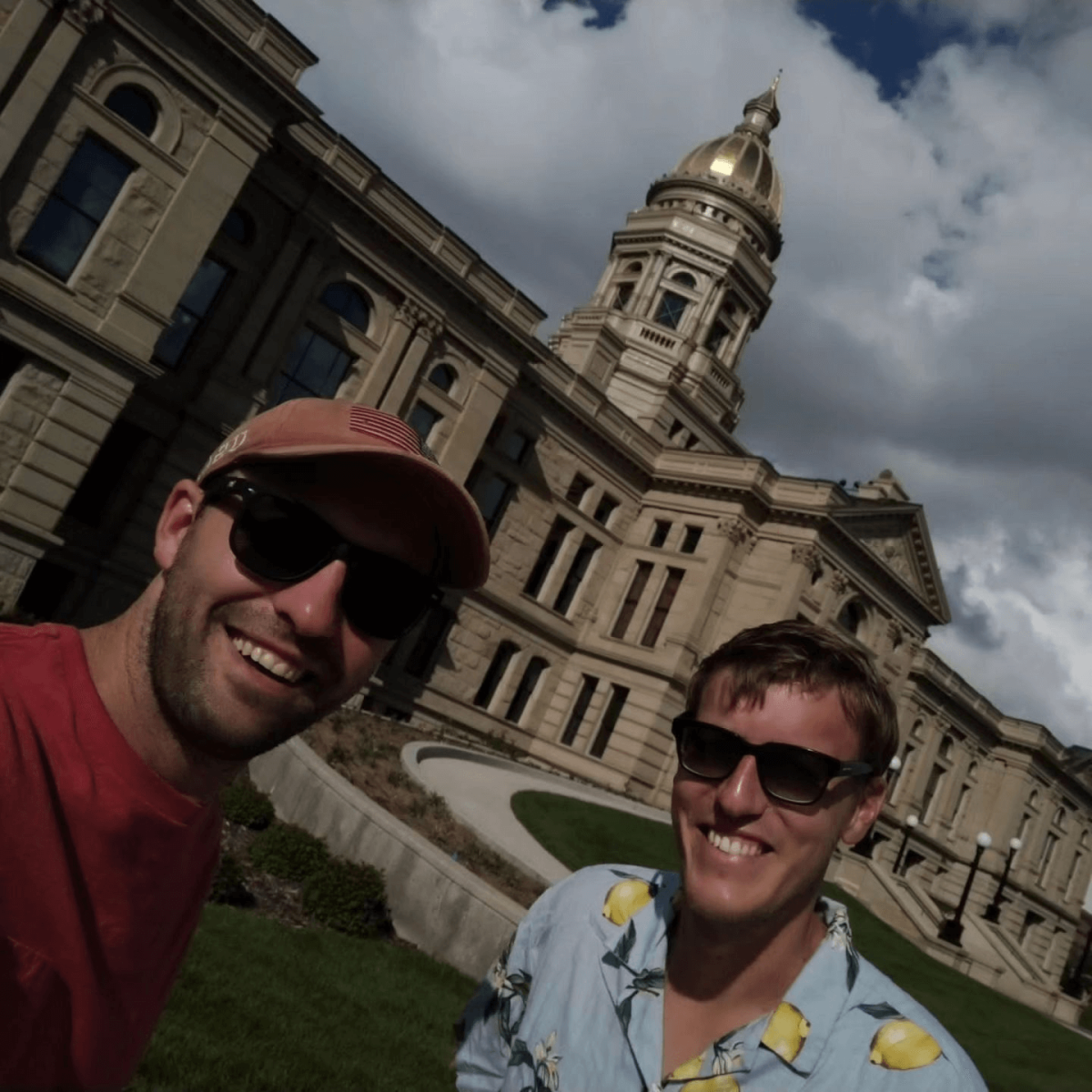 Two friends taking a selfie at the Cheyenne State Capitol Building.