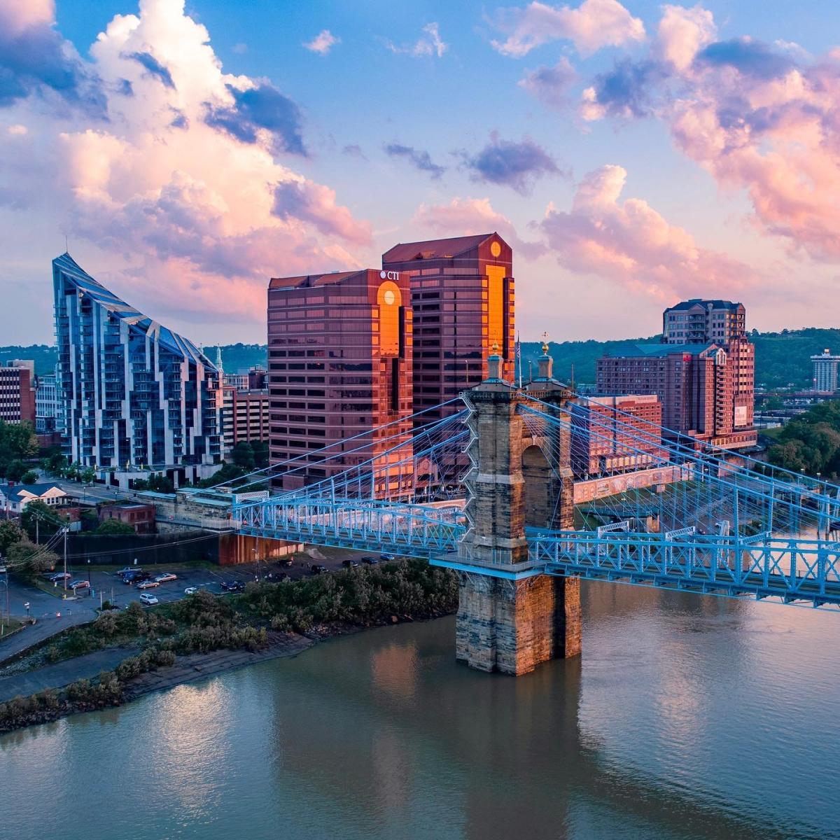 The skyscrapers, The Ascent and Rivercenter Towers behind the Roebling Bridge and Ohio river on a sunny day