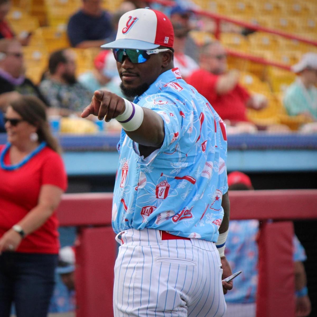 Image is of a Florence Y'alls Baseball player looking over his shoulder and pointing at the camera.