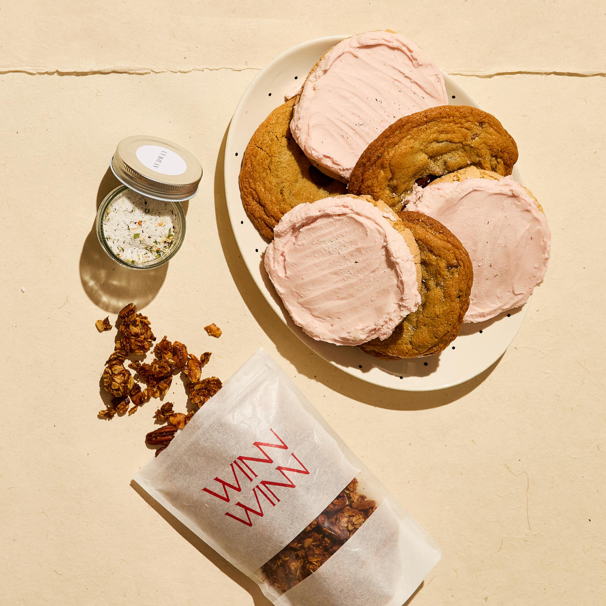 Plate of cookies, bag of granola, and salt blend from Winn Winn