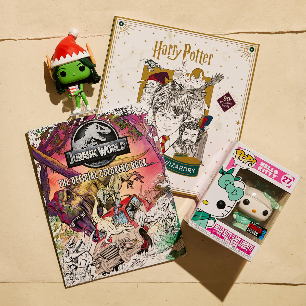 Variety of games and toys, including a Harry Potter coloring book and Hello Kitty Vinyl Figure