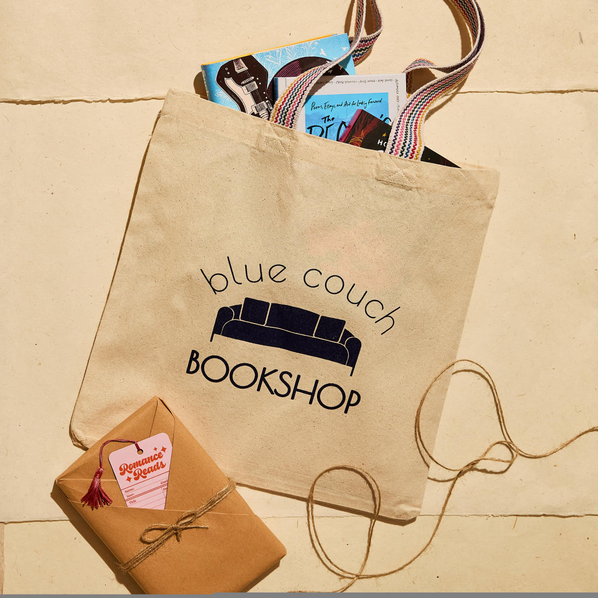 Blue Couch Bookshop tote bag filled with books