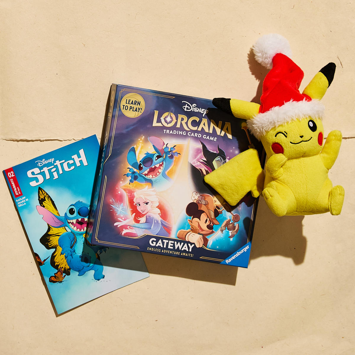 Disney "Stitch" book, "Lorcana" trading card game, and a stuffed Pikachu with a Santa hat