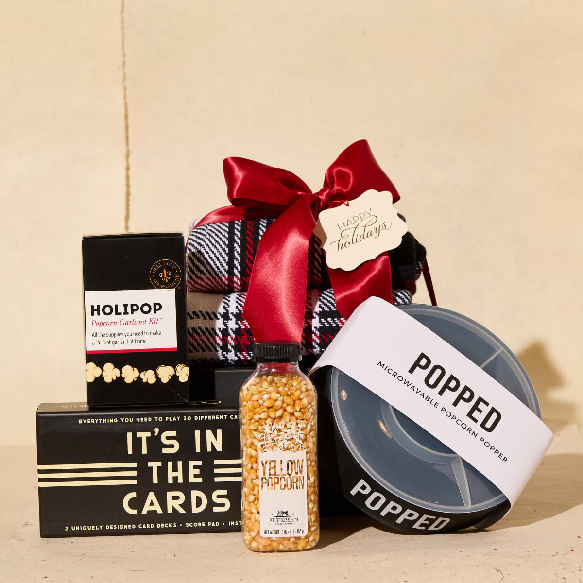 Movie night kit with a Popcorn Garland kit, popcorn popper and kernels, blanket, and card game