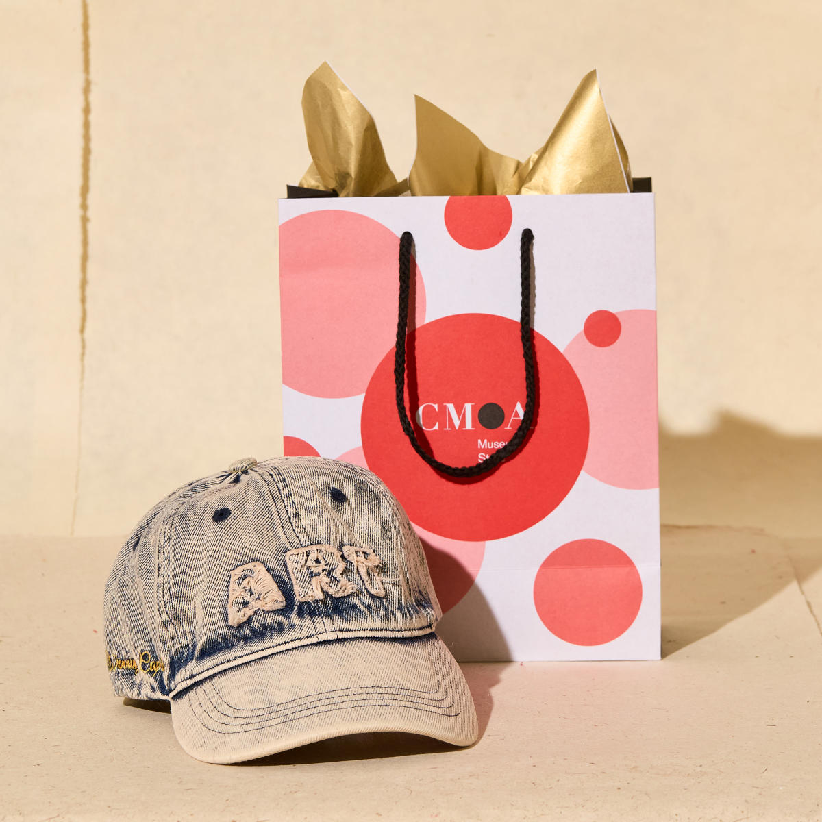Denim hat with the word "ART" on it from the Columbus Museum of Art