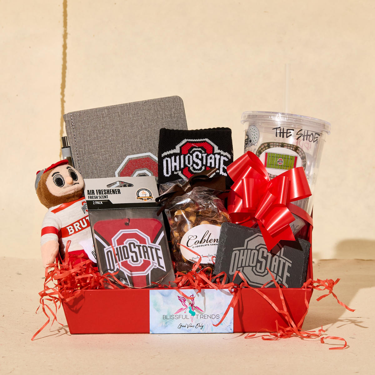 Basket of various Ohio State branded items, such as a tumbler and air freshener