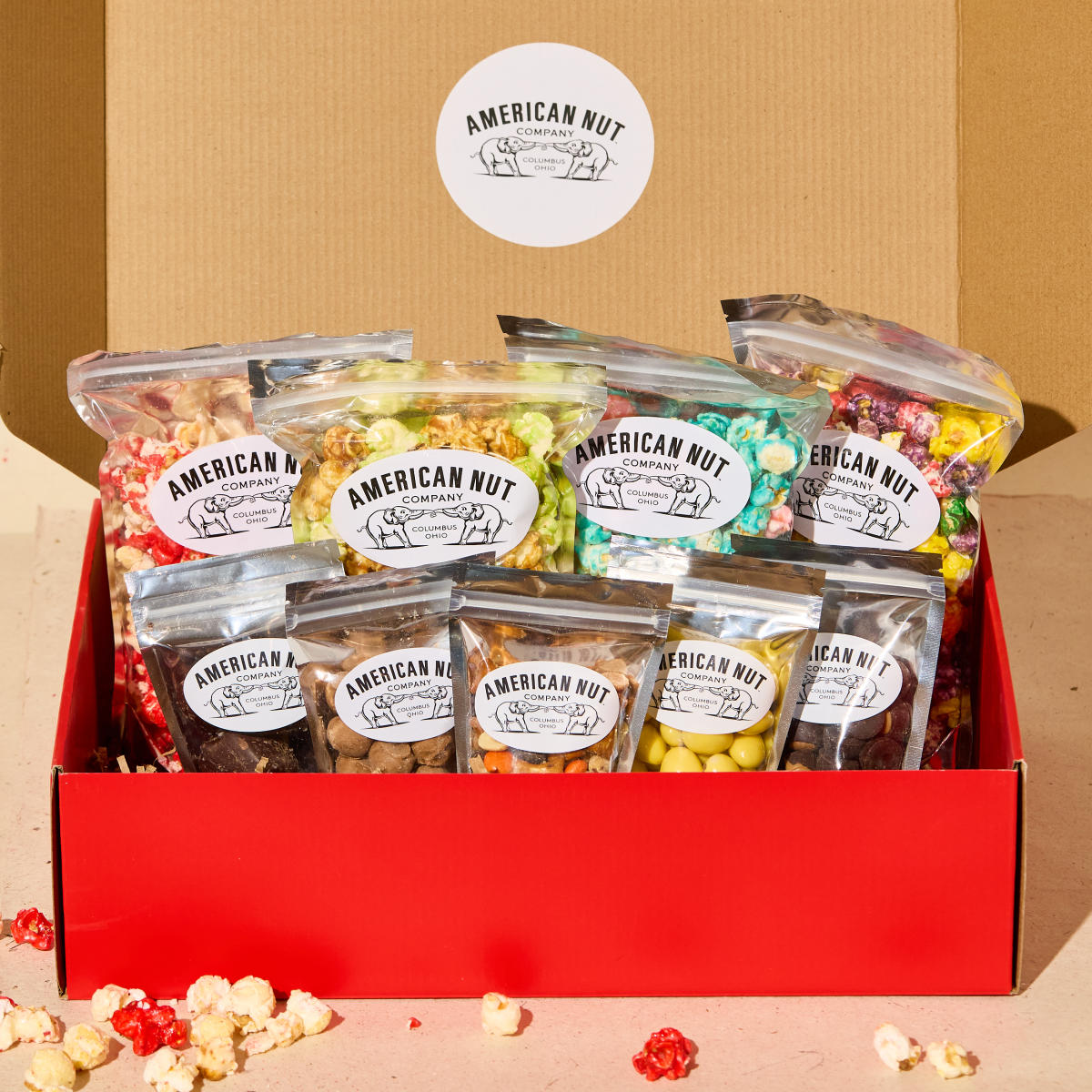 Large box of assorted flavored popcorn and nuts from American Nut Company