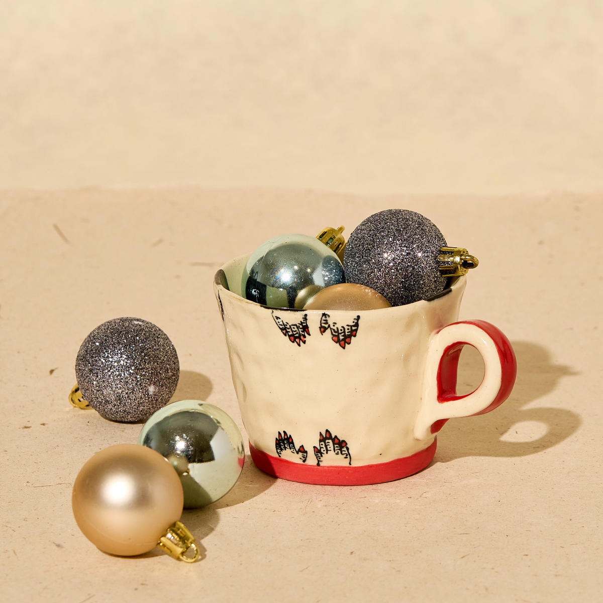 Clay mug with fingertips painted along the edges from Chaos Contemporary