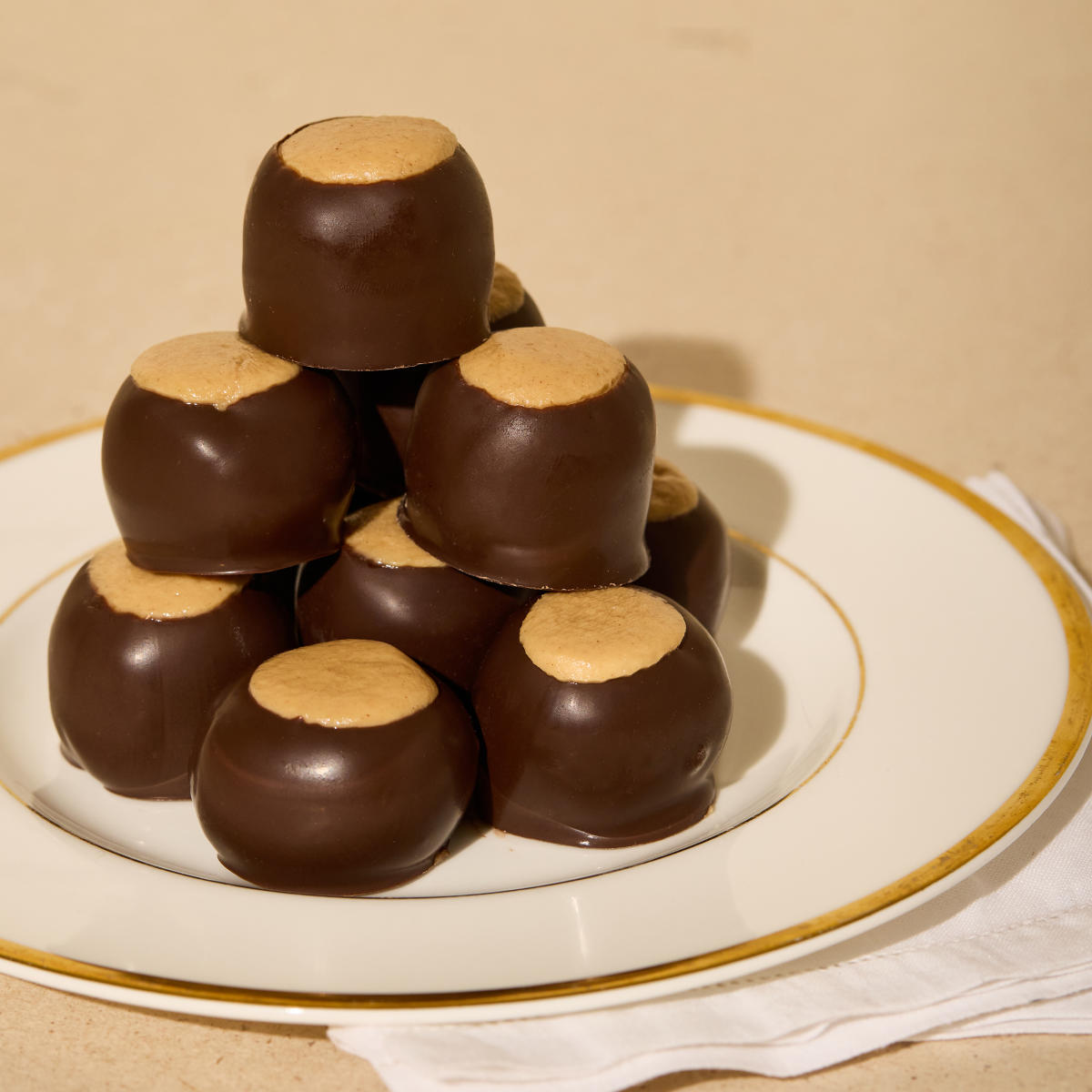 Buckeyes stacked on a plate, made by The Buckeye Lady