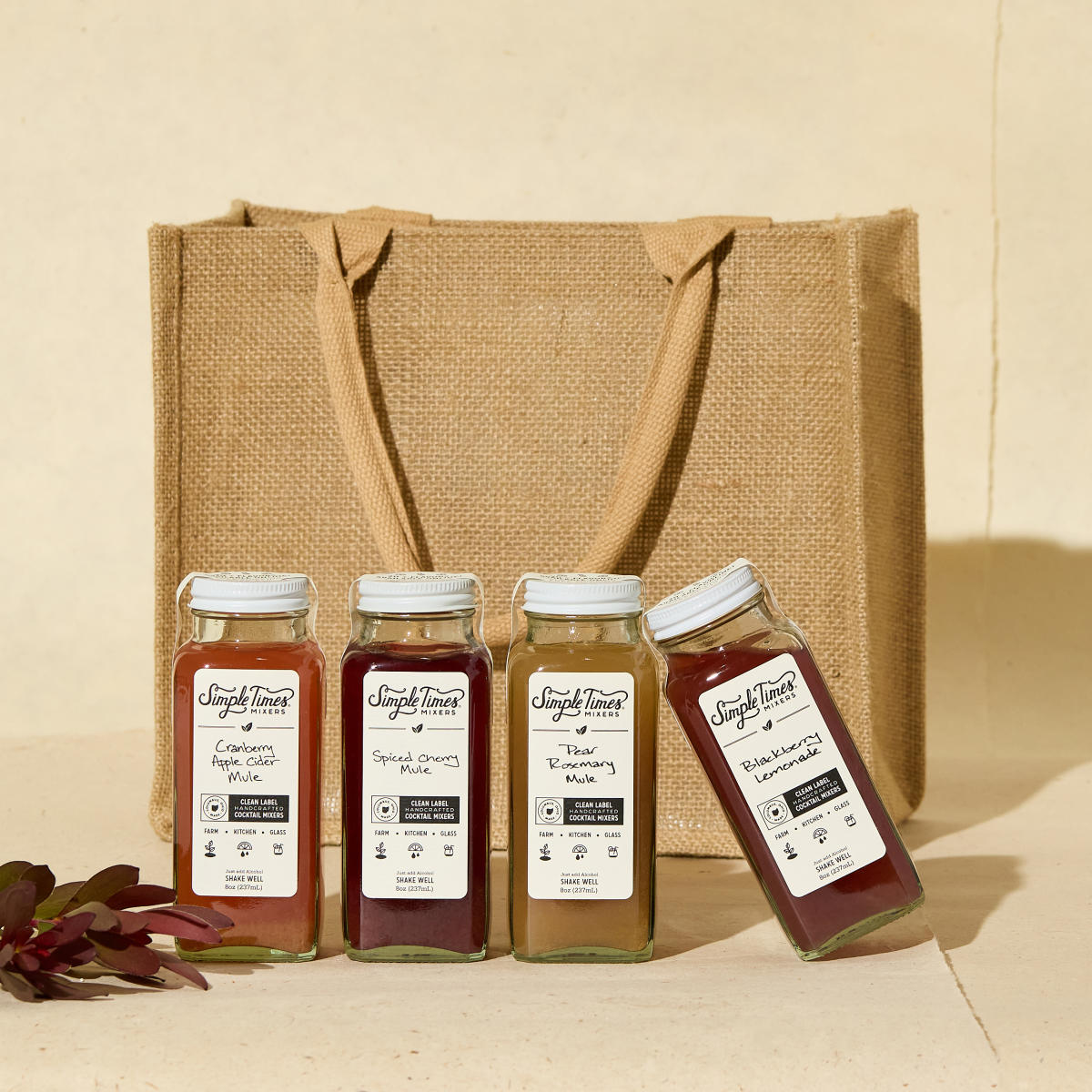 Four bottles of different flavored cocktail mixers