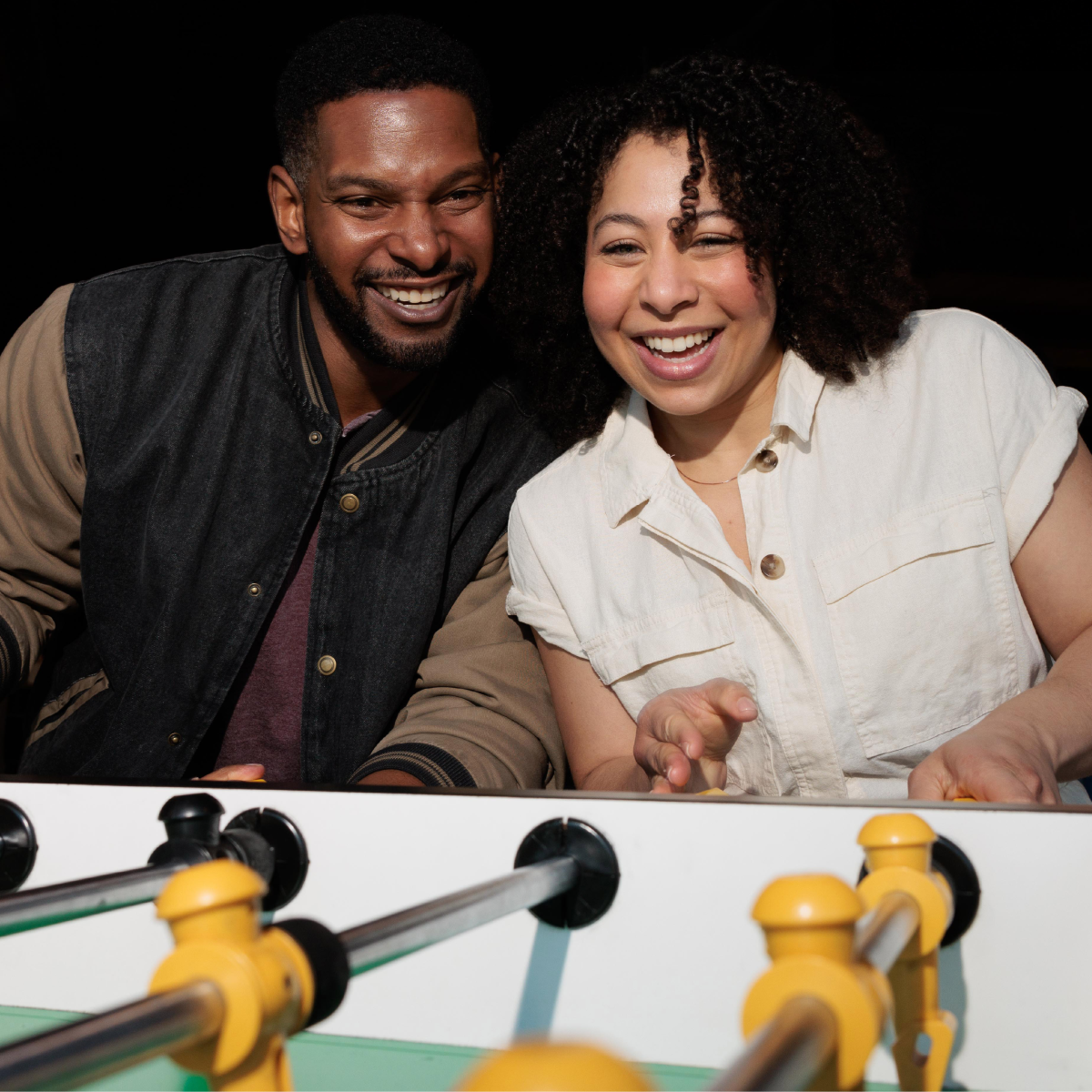 Man and woman playing foosball