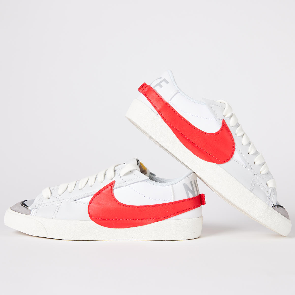 White Nike sneakers with red swoosh from Sole Classics