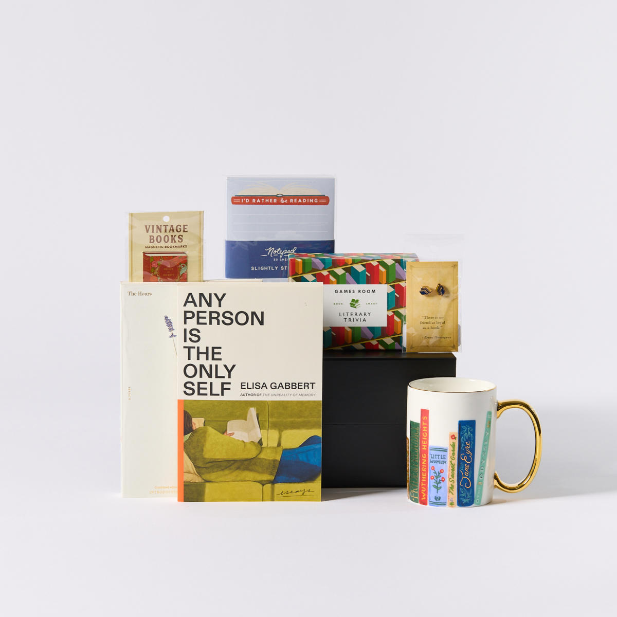 Assortment of books and a mug with books from Storyline Book Shop