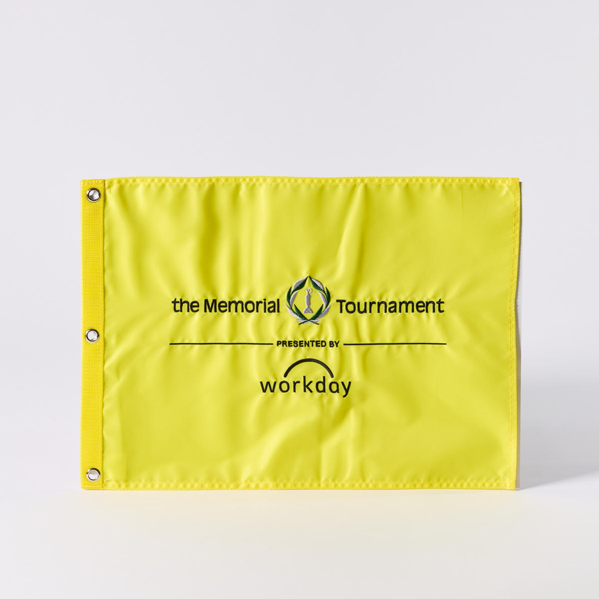 Bright yellow golf pin flag that says "the Memorial Tournament, PRESENTED BY workday" on it
