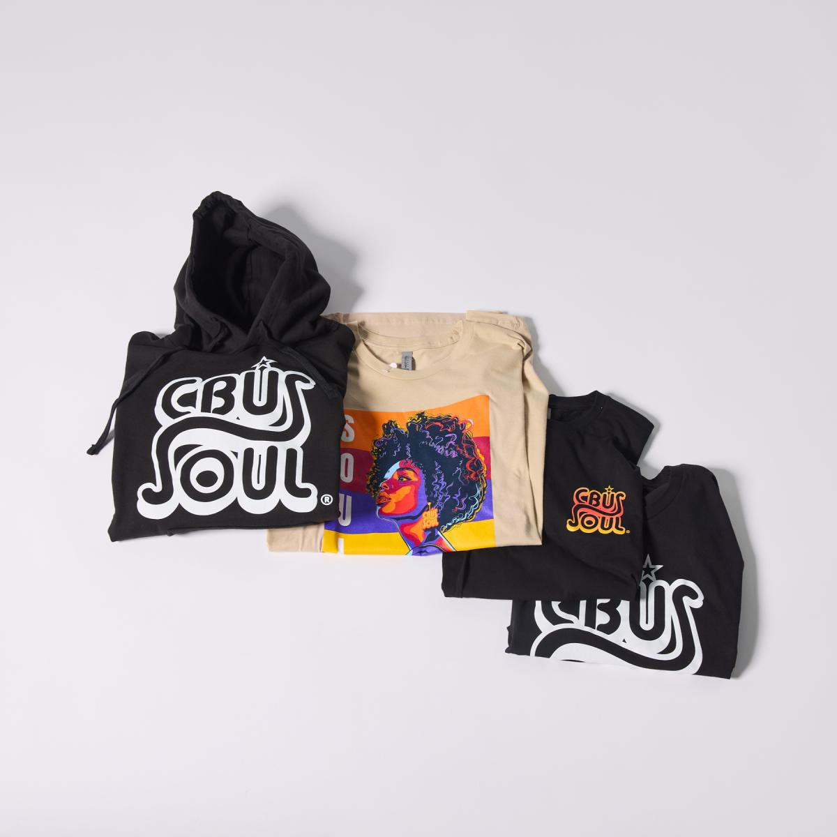 Four CBUS Soul® apparel items — a hoodie, crewneck, and two t-shirts