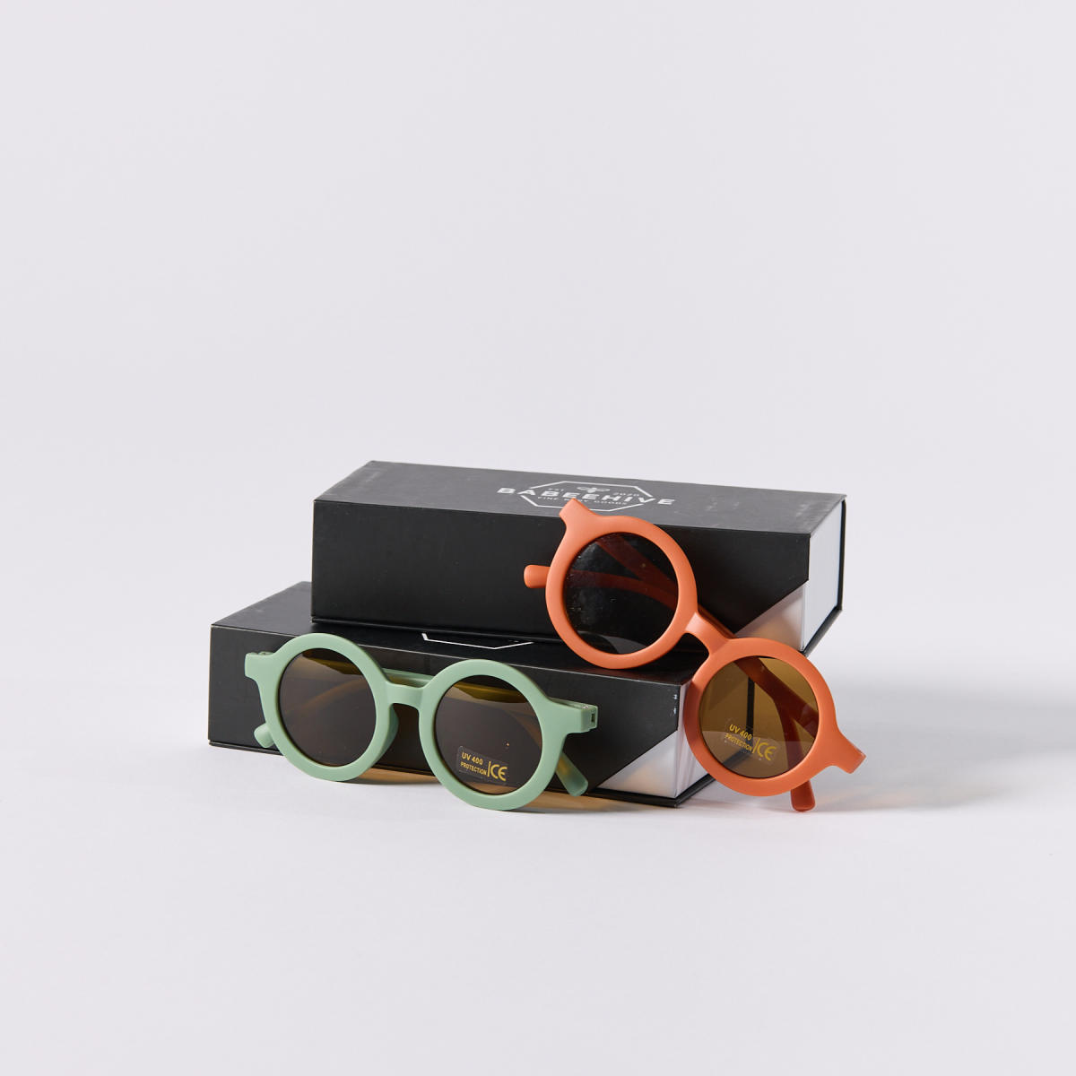 Two pairs (one green, one orange) of retro sunglasses from Jamison & Bexley
