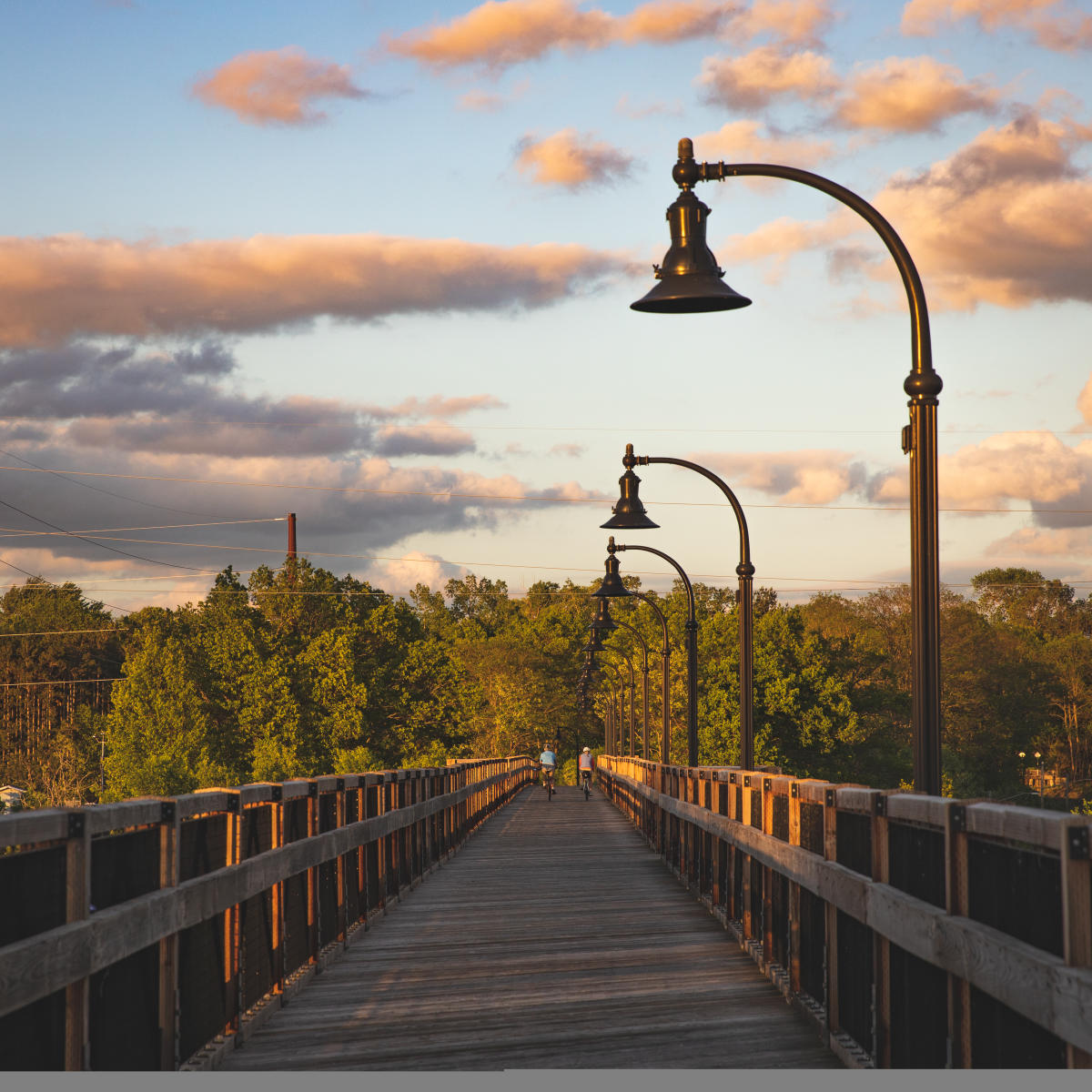 People biking on High Bridge around sunset