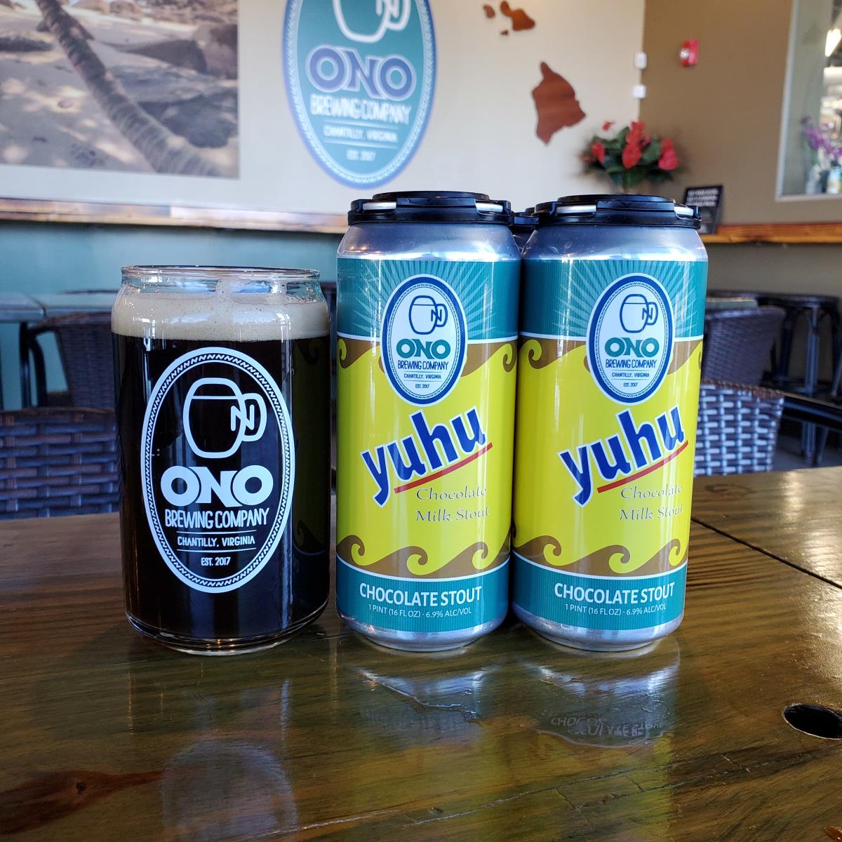 A full pint of chocolate milk stout beer sits next to two cans of the same beer at Ono Brewing Company in Chantilly