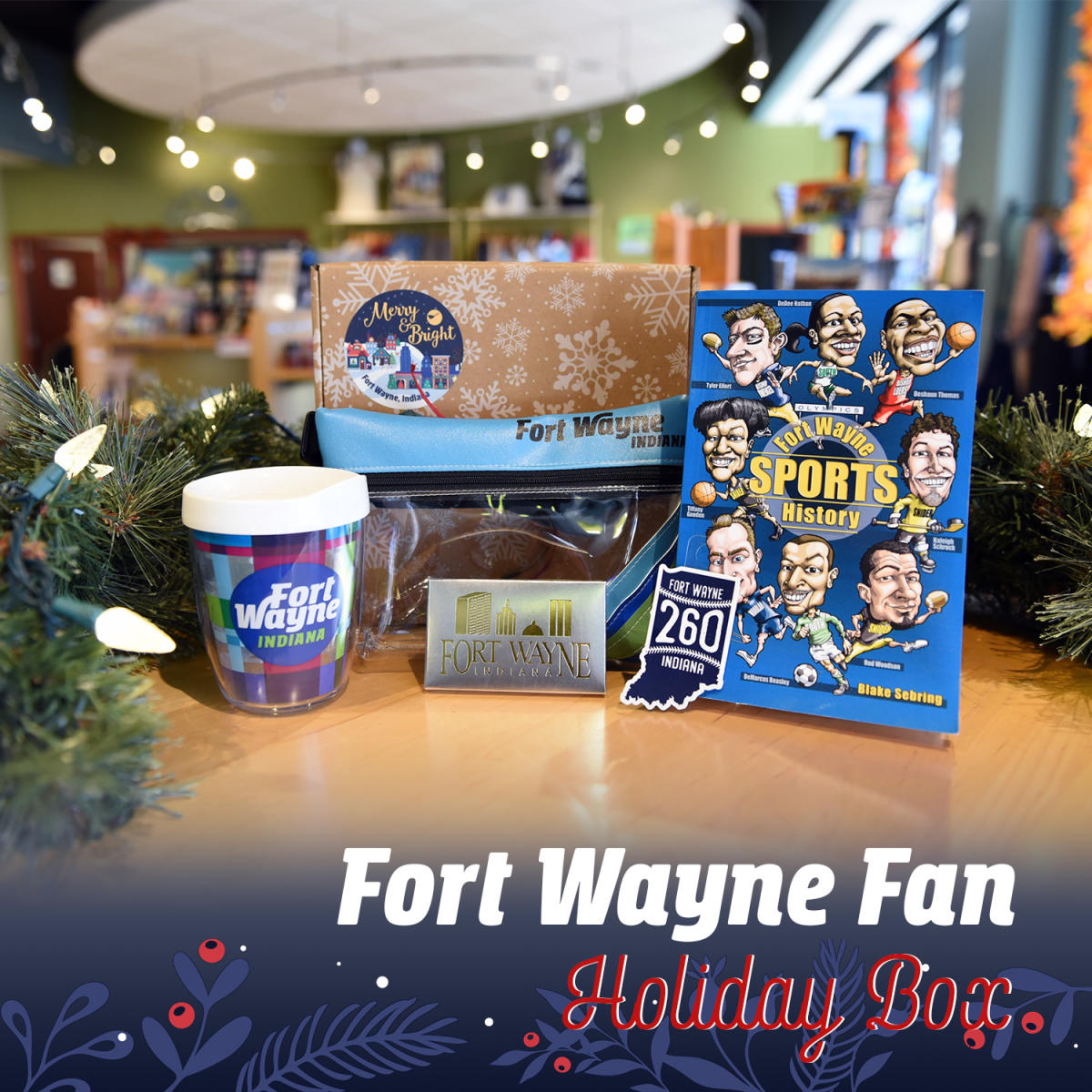 Gift box showing 12oz thermos, Indiana state 260 magnet, clear Fort Wayne zipper pouch, Fort Wayne chocolate bar, and Fort Wayne Sports History book.