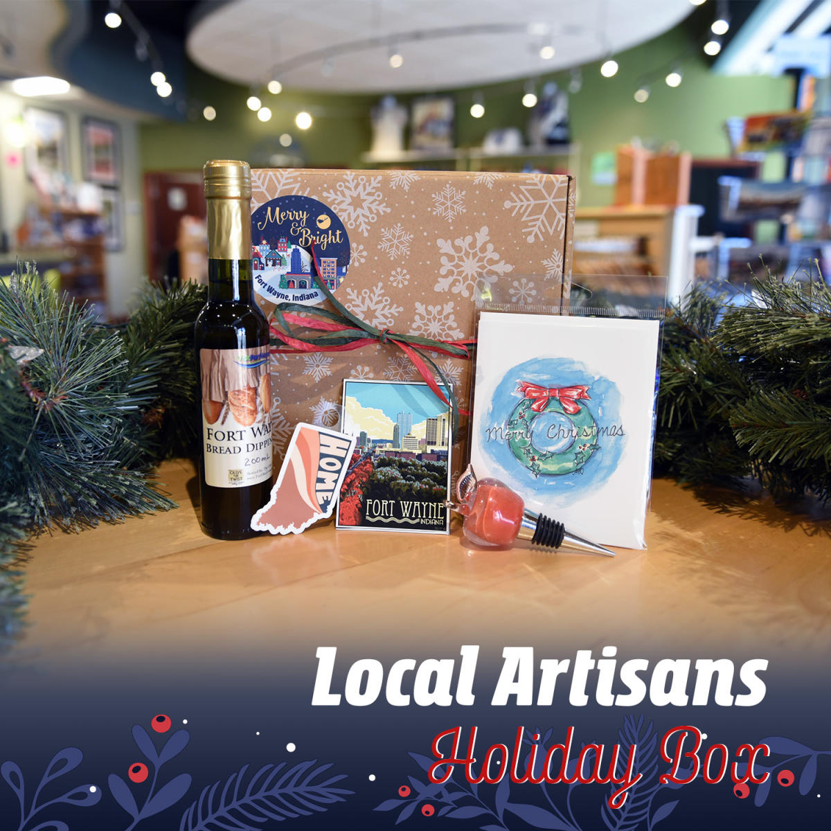 Gift box showing local olive oil, glass apple wine stopper, and Indiana state sticker, skyline postcard, and wreath notecard done by local artists.