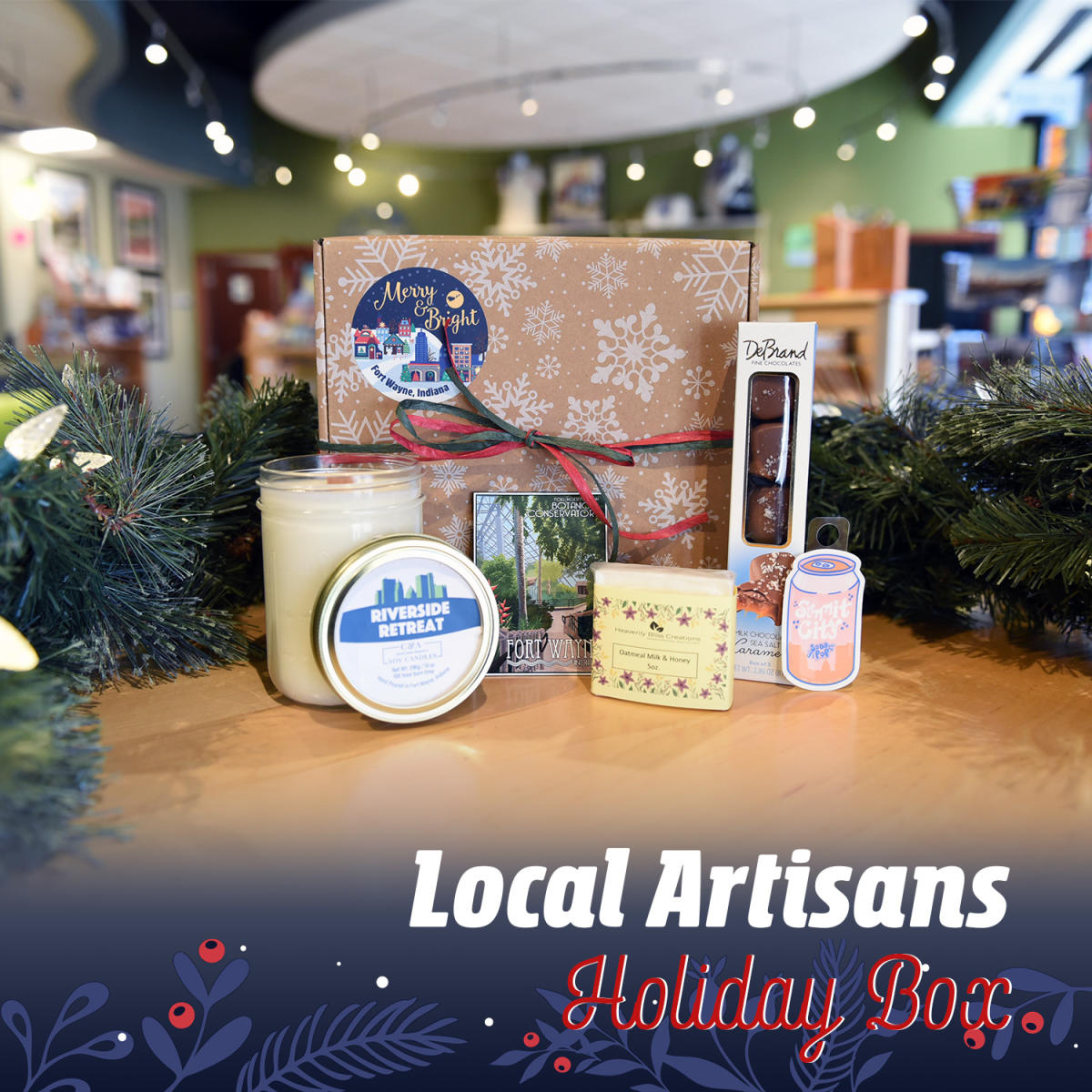 Gift box showing local candle, soap, chocolates, and Summit City sticker and Botanical Conservatory postcard done by local artists.