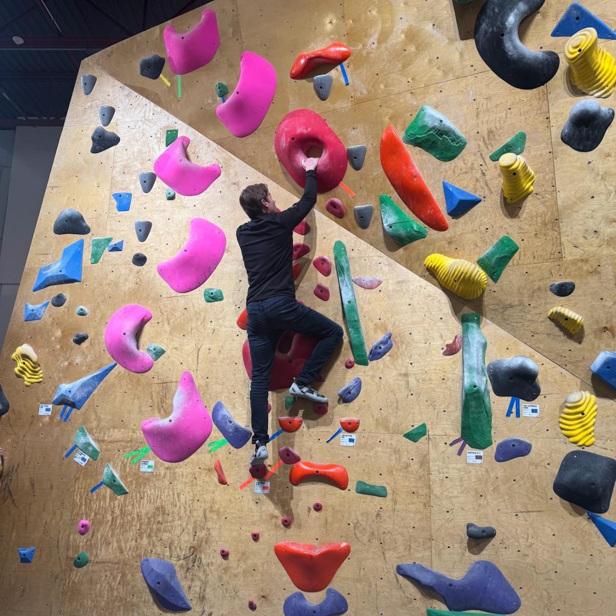 @youngleadersnei on Instagram. A team member scales the wall at Summit City Climbing Co. in Fort Wayne