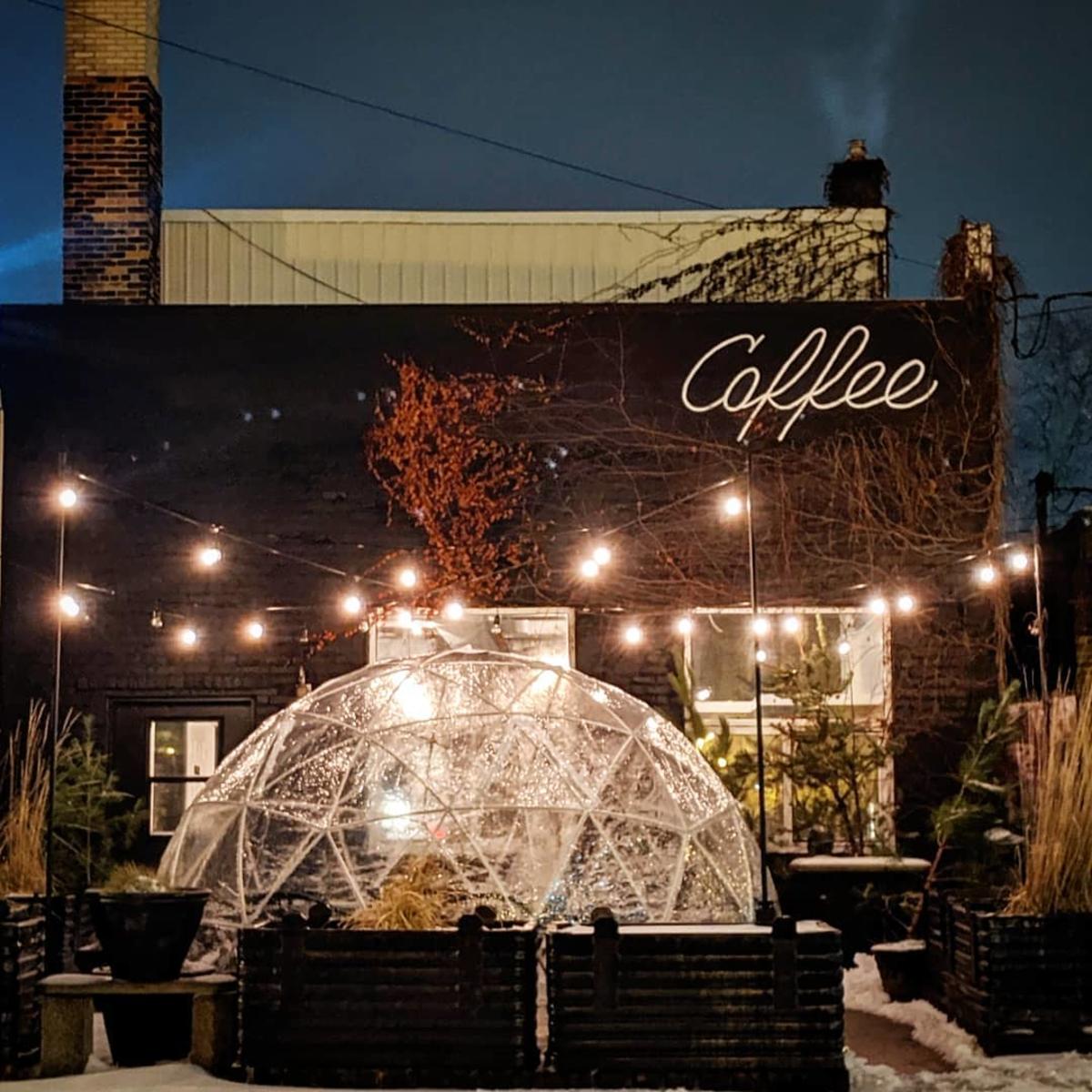 Outdoor igloo at night under the bistro lights in winter at Harless + Hugh Coffee in Bay City