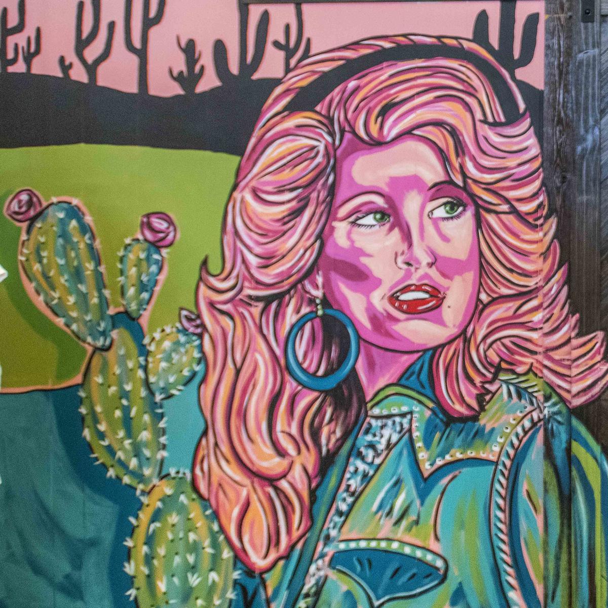 Dolly Parton looks on in a mural located inside the Swanky Steer store in Fountain Inn, SC.
