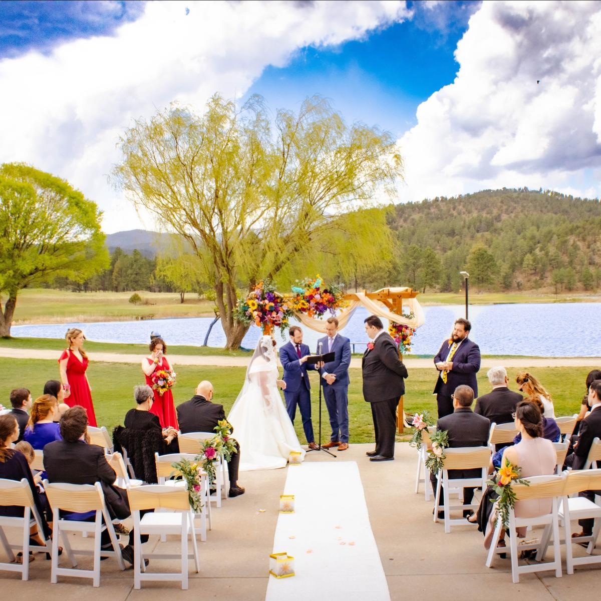 Wedding ceremony with guests seated lakeside at Inn of the Mountain Gods in Ruidoso, New Mexico.