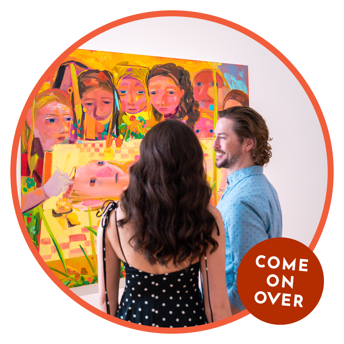 A man smiles in profile at a brunette woman as they stand in front of a colorful work of art in Overland Park.