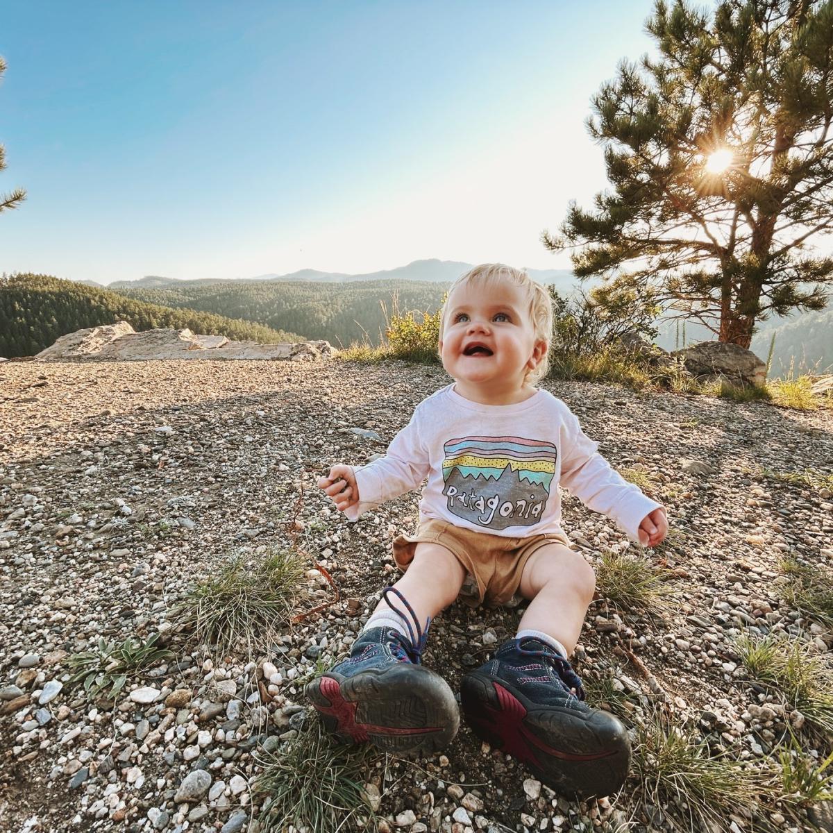 child on the stratobowl rim trail with black hills national forest views behind