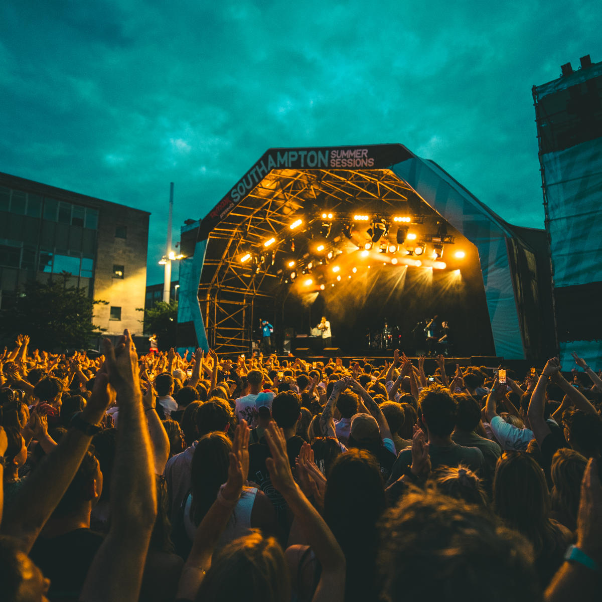 Loyle Carner performing on stage in front of cheering crowd at Guildhall Square for Southampton Summer Sessions