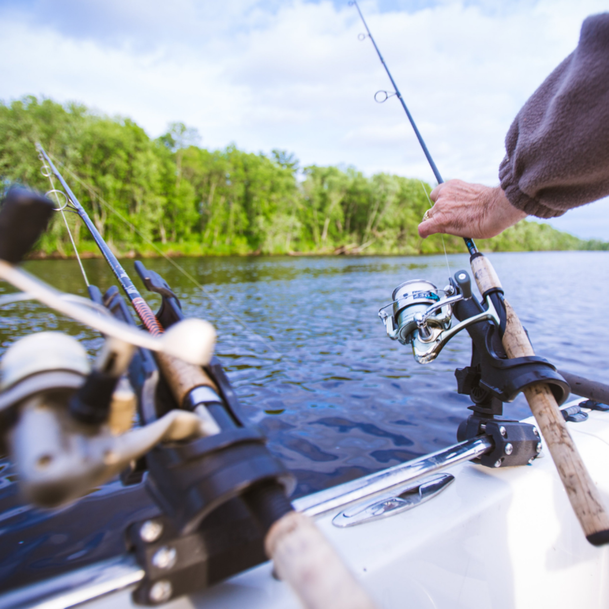 fishing poles, boat, water