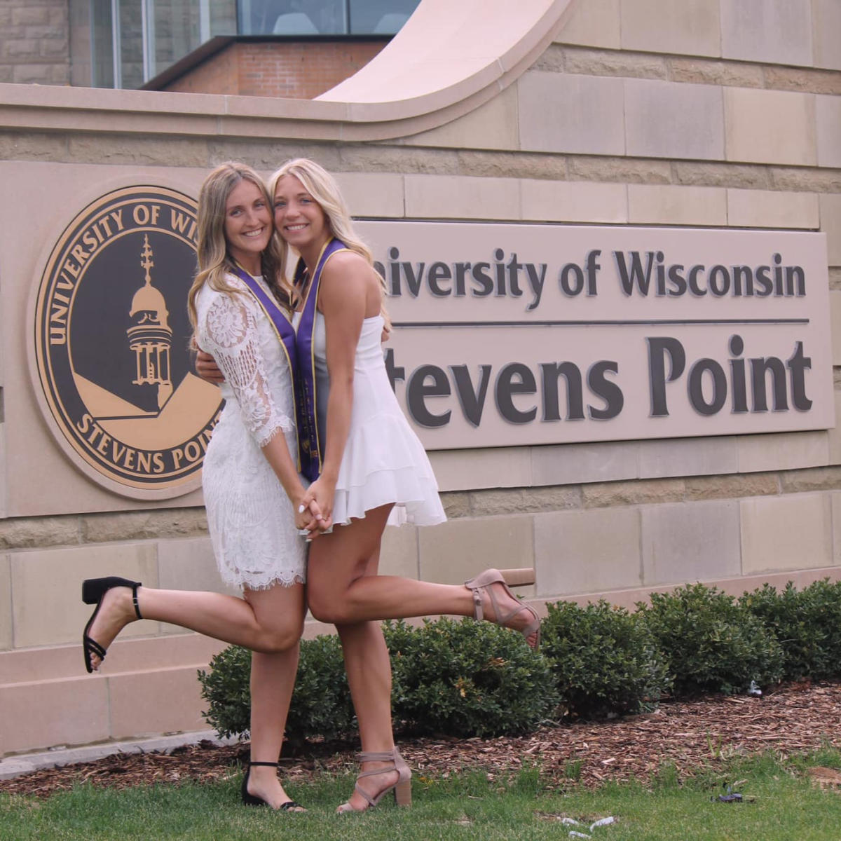 Graduation image in fron of uwsp sign