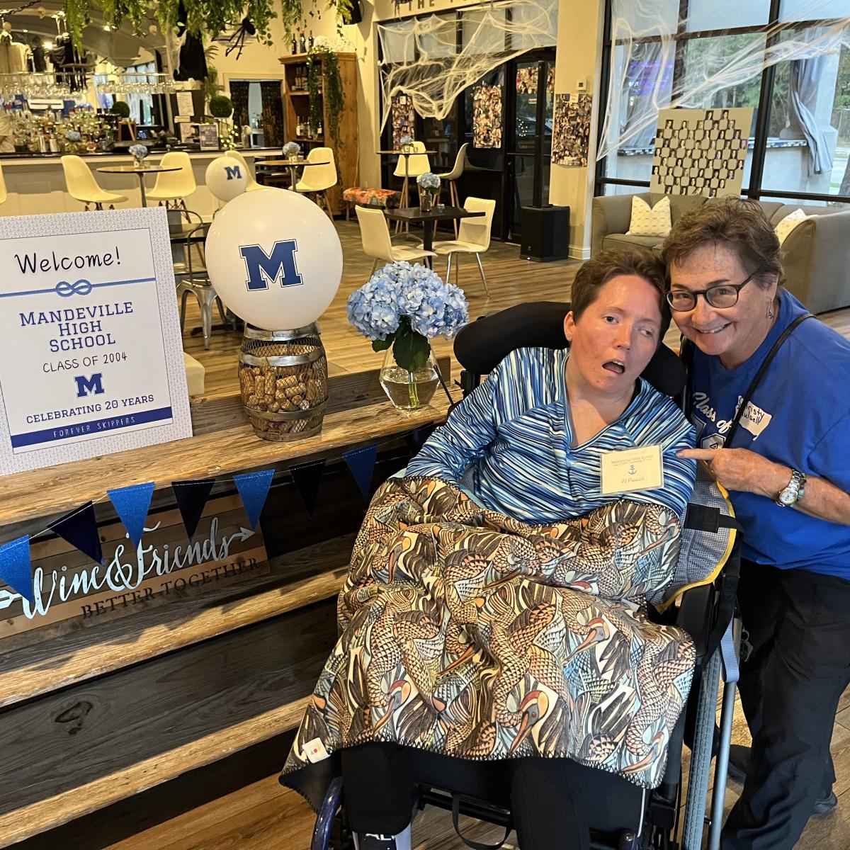 Christy and PJ at Mandeville High School reunion inside St. Ann Wine Bar, with ADA-accessible space and décor.