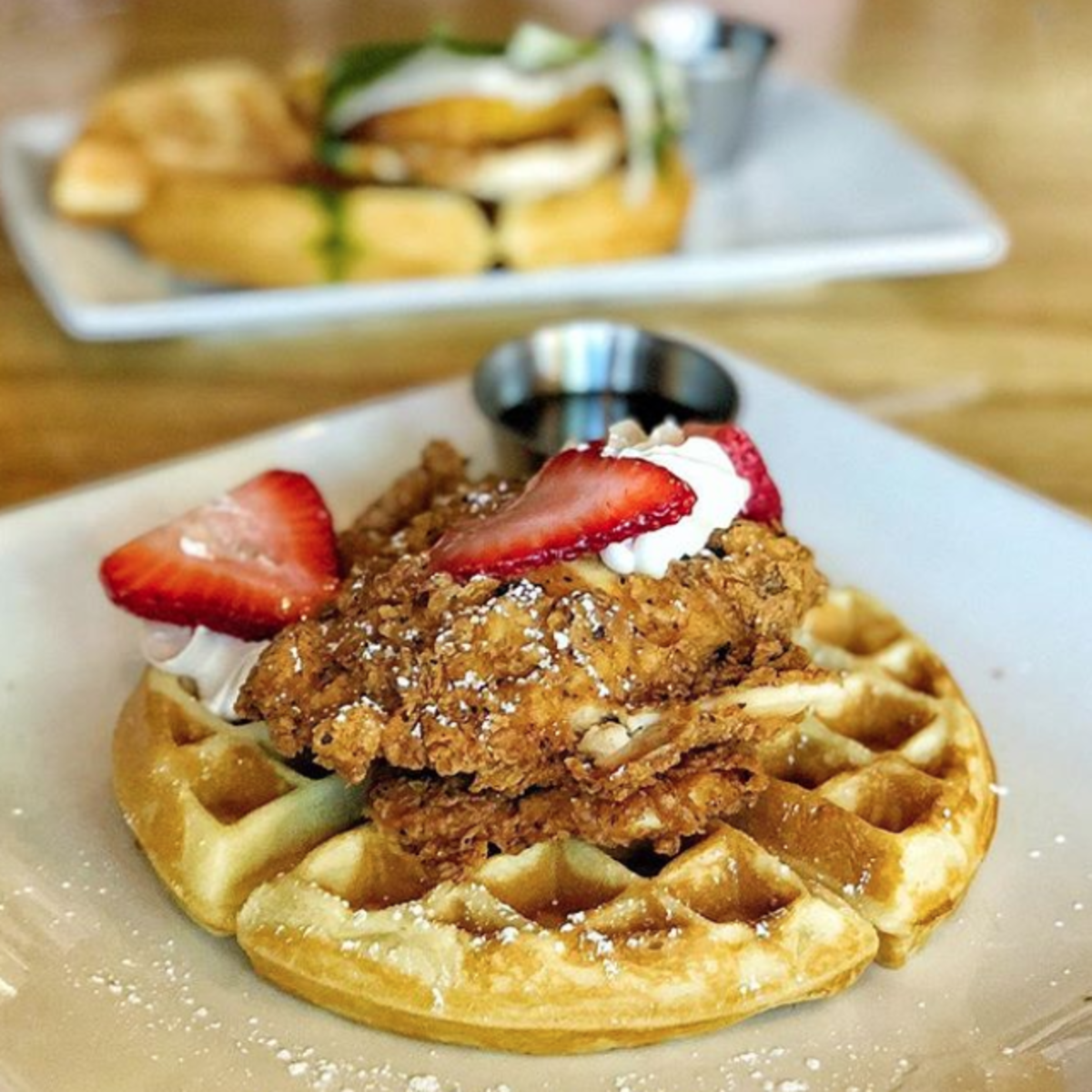 Chicken and waffles topped off with strawberries at Jupiter Pizza & Waffle Co.