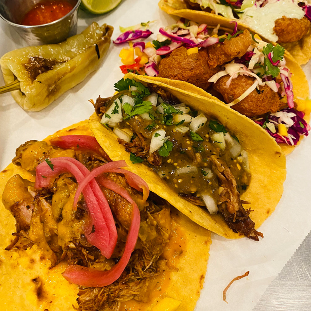 Que Vida Tacos. Image of three tacos on a table